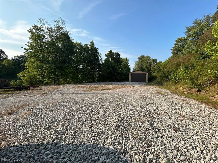 Property being surveyed and will be approximately 4.33+/- acres, taxes will have to be reconfigured. Offers a fantastic pole building that is well insulated, concrete floor, 28x58, 14' overhead door, interior pulldown shutter over windows for additional security.  Water is at the building and on the property.  Public sewer is available at the road. Within a mile of Interstate exit.  This property could also be used for a homesite with a pole building in place.  Mineral rights do not transfer. Building was built in 2008.