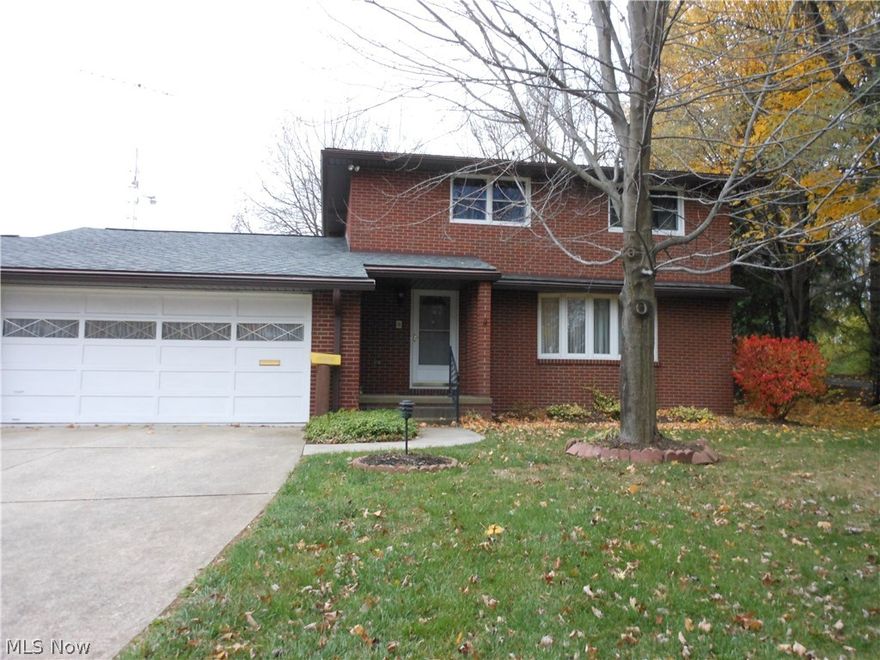 Outstanding quality in this brick 2 story in beautiful Menlough Estates! 3 bedrooms, 2 baths (one is in basement) , formal living room with bow window  and curved oak stairway,and dining room. First floor family room with gas log fireplace and sliding glass doors out to lovely park-like backyard! Glazed tile oversized 2 car garage plus adjoining 14 x 23 enclosed porch perfect for family gatherings. Eat-in kitchen with oak cabinets, duraceramic flooring. Hot water heat with newer central air . 
Bedrooms have hardwood flooring, vinyl replacement windows, and ceiling fans. Updated electric service, new roof in 2008. Just needs your updated cosmetic touches!