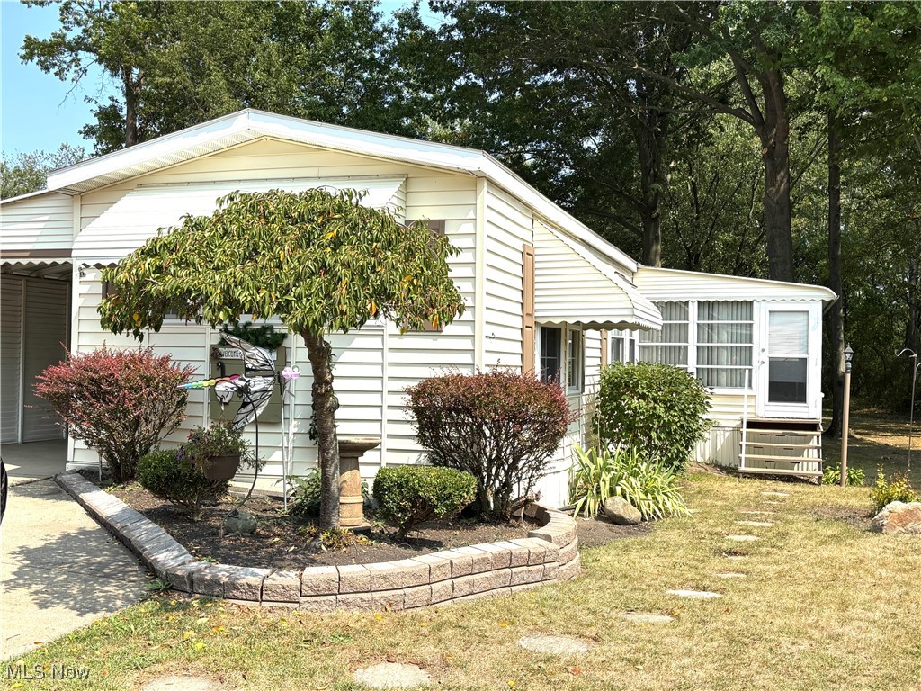 Located in Southern Terrace Mobile Home Park, a 55+ community. This home is move in ready. Living room with cathedral ceiling, large kitchen with refrigerator, range, dishwasher, lots of cabinets and counter space, and desk area. Master bedroom with private bath and double closets. Second bedroom and additional bathroom with walk in shower. Laundry area in hallway for convenience. Beautiful sunroom with sliding patio door. 30x10 carport. 12x10 shed with electric. Gas furnace and central air for year round comfort. Beautiful landscaping surrounds the home. Extra deep lot gives the sense of a country setting. This 1996 Shamrock Home is immaculate inside and out. Purchaser must be approved by park management. Lot rent includes trash service.