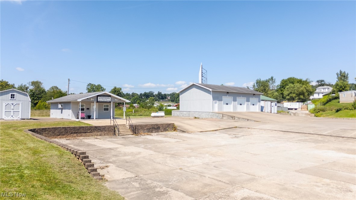 COMMERICAL PROPERTY OPPORTUNITY!! a highly adaptable 11-acre commercial property offering exceptional potential for a wide range of business uses. The site features a 32' x 40' industrial building, formerly used as an automotive repair facility, with three spacious service bays, each equipped with 14' x 12' overhead doors, along with side-loading docks for efficient access and distribution. An integrated office within the main building supports operational needs, while a separate standalone office building provides flexible space ideal for administrative, customer-facing, or professional functions. A large concrete pad on the property allows for substantial parking or outdoor storage of vehicles, RVs, trailers, or heavy equipment. With its ample space, functional infrastructure, and strategic layout, this property presents numerous possibilities for automotive, logistics, light manufacturing, equipment storage, or other commercial and industrial applications. Call today to schedule your showing.