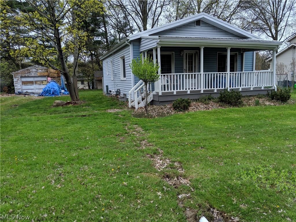 This is a Short Sale Opportunity, great potential on this Ranch Home with awesome front porch to sit on. Home has 2 bedrooms with wood flooring, 1 large bathroom, Awesome sized Living Room with wood floors and pine wood ceiling & ceiling fan, Dining Room is open to Kitchen with Eating breakfast bar and great layout for cooking and serving! Home has Newer High Efficient Furnace, Newer On Demand Hot Water Heater, and newer Plastic Plumbing, Newer Vinyl Siding on the front and newer porch soffit, Newer Vinyl Windows, Newer Metal Roof, some updated wiring with more needed to be updated. Detached Shed is in need of repairs or removed from premises. 1+ oversized Garage in need of repairs and exterior coverings. This home will not go FHA regular financing, it would need to be a renovation loan due to some floor coverings needed in Dining room and electrical repairs, handrail to basement, some exterior trim coverings needed, garage repairs and miscellaneous work like rear deck and old shed rem