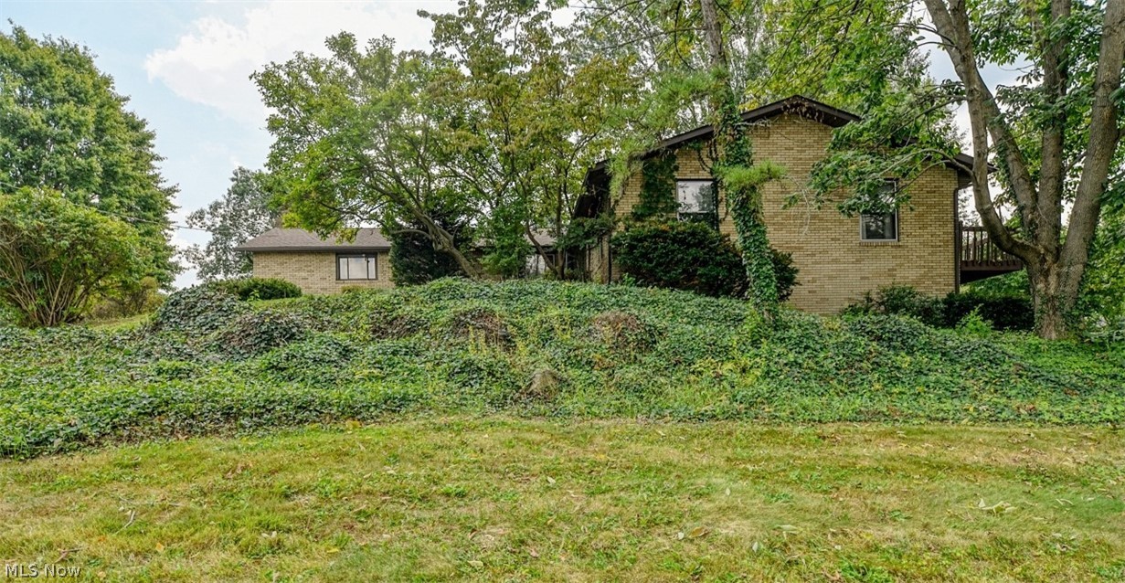 Great potential for this spacious 4 bedroom, 2.5 bath ranch home with 2 car attached garage in the Bird allotment with Ravenna mailing address and Rootstown schools. Vaulted, beamed living room with floor to ceiling windows, sliders to the balcony/deck overlooking the side yard, spiral staircase to the finished walk-out lower level with family room, recreation room, bedroom and full bath. Fenced backyard and shed. This will need some elbow grease to bring it back to glory days, but the potential is huge!