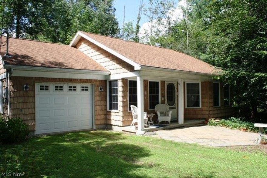 Nestled on a wooded lot, you will find this adorable cottage. Walk into the open space of the living room, kitchen and eating area. The master bedroom has lots of storage. The second bedroom boasts a built in bed and a loft area. A four season room with sliding glass doors gives plenty of natural light. This home is very private, but just a house and a parking lot from the pool beach, club house and other amenities that Cinnamon Lake has to offer. If charm is what you are looking for you will find it in this home.