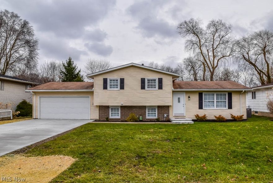 Beautiful 3 bedroom home with a large backyard and updates throughout! Fresh paint, neutral colors, all new flooring, new windows, new exterior doors, newer high efficiency furnace/AC, brand new driveway and more! Prepare your favorite dishes in the remodeled kitchen with stainless steel appliances, tile backsplash and white cabinetry with nice hardware. Entertain guests in the open living and dining room with a sliding door to the backyard. Upstairs, there are 3 bedrooms and a gorgeous full bath with a dual sink vanity and deep built-in storage. Downstairs, enjoy the massive family room with new carpet and direct access to the 2-car attached garage. Nicely landscaped yard with a patio and a 10x12 storage shed. Fantastic Perry neighborhood! Come see all this home has to offer!