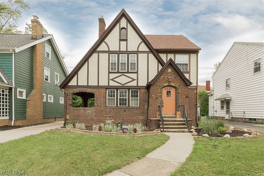 Picturesque tudor style brick-stone-stucco-shingle 4 bedroom 1.5 bath house completely updated. All new kitchen with white wood cabinets, glass and porcelain tile and stainless appliances. Updated bathrooms, all new hardwood and tile floors throughout with original natural trim, stone fireplace, newer 2 car garage, newer roof, and many new windows, waterproofed basement. rear deck, enclosed back porch, and a side porch with arched stone front. Move in ready