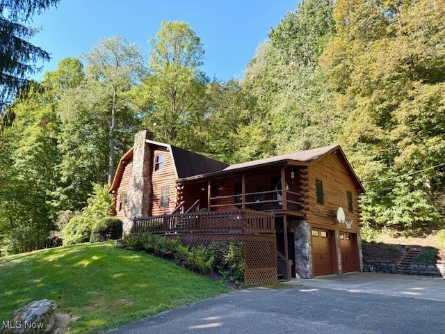 Well maintained 4 bedroom, 3 bath, log home surrounded by woods and nature. You will feel like you are vacationing in the Smokies. The expansive great room with a towering fireplace chimney built with stones from the site, as flames flicker in the Mendota propane fireplace reflecting off the logs and beans of the cathedral ceiling, this is where you will want to celebrate the holidays and cozy winter evenings in your forever home. The spacious kitchen with cherry cupboards and wood floor crafted from the trees of the property sports a 14 seat extension table to host your turkey dinner. A stone patio off French doors leads to a gardened pathway to an adorable guest cottage for your overnight guests. The loft overlooking the great room fireplace - with custom counters and desk is ideal for crafting, studying or a fifth bedroom. The office with custom built shelving, counters and desk leads to the first master suite with newer wood flooring and private bath. At the opposite end of the main floor the second master suite with its adjacent bath, enjoys sunny south exposure, newer wood floor and walk in closet. The lower floor offers the perfect retreat for your teens or guests with two bedrooms, a bath, a rec room with a Harmon pellet stove, laundry with Speed Queen washer and dryer and the two car garage, as well as storage spaces. You will enjoy water from the new 380’ well, new Insulated Wayne garage doors, Malta replacement windows, newer flooring on most of the first level and bedrooms, central vac, reverse osmosis water purification, gutter guard, updated bathroom fixtures, and underground pet containment fence in the yard. With the pond stocked with fish, the boat, stream for catching frogs, hills for sledding, fire rings, small barn for garden equipment and ATV’s, a shed, trails in the wooded acreage – you have discovered a rare idyllic paradise for raising a family, hosting guests or relaxing in this once in a lifetime dream opportunity in the outskirts of Dover.