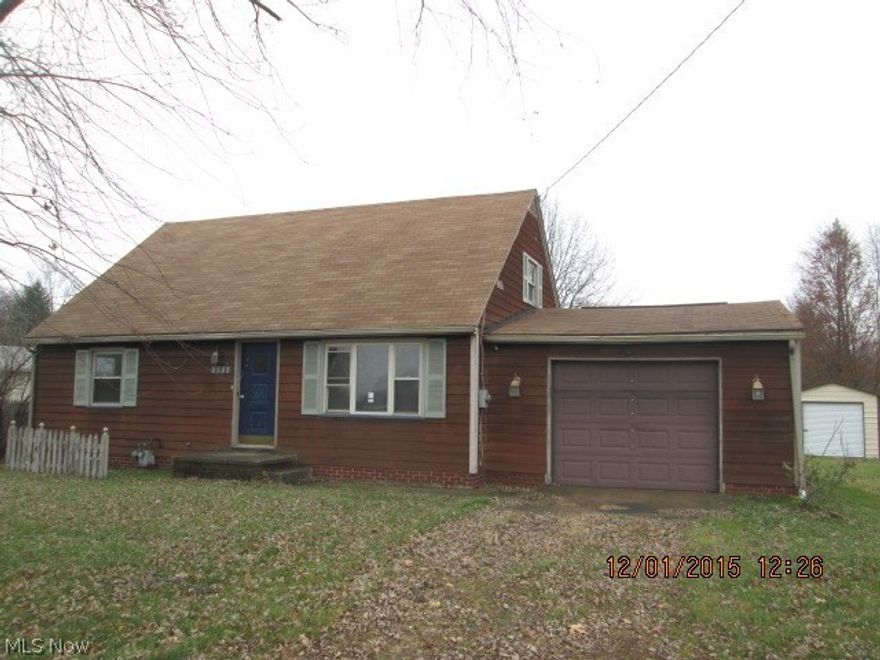 4 bedroom bungalow with large deck, attached garage & newer storage shed.