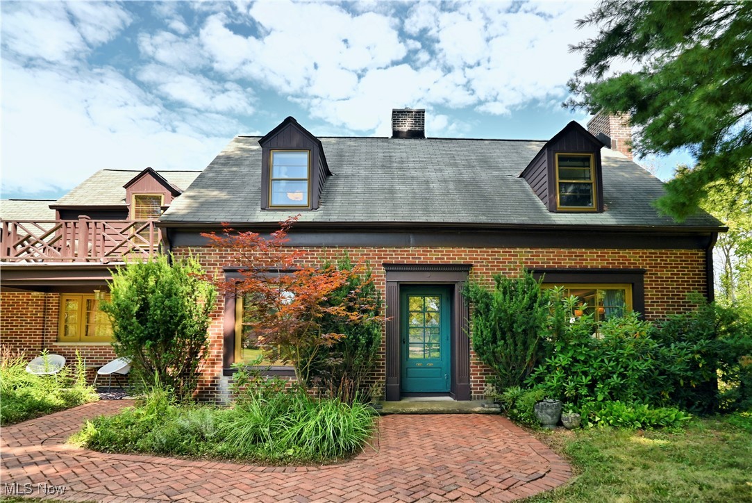 Built in 1949, this classic brick home is full of architectural details and built-ins that give the house character. Reached by a long driveway that overlooks a stunning mature landscape, it offers a three-car garage, brick walkways in front and back, multiple patios, and an elevated brick patio that offers privacy and relaxation. Inside, the first floor offers a large kitchen with original cabinets, light-filled dining room, office with built-in shelves, a family room that can also be used as an in-law suite, and an elegant, large living room surrounded on three sides by windows and sliders to the patio and a classic marble and wood trimmed fireplace at its center. Four bedrooms on the second floor feature more built-ins and nooks that will delight adults and children. Ask about the hidden closet behind the bookcase in one of the bedrooms! The partially finished basement has a theater/viewing area for family gatherings and a workout area.
The two-acre lot is primarily open with multiple patios near the house and a wooded area on one side of the backyard. The owner has created a footpath that leads to a clearing in the woods with seating and lights for private gatherings, surrounded by nature.
This house was purchased in 2020 by an artist/musician and is uniquely and beautifully decorated. It has been featured in Cleveland Magazine and other publications.
All outdoor furniture, including a pergola, stays with the house, as do several mid-century modern pieces.
