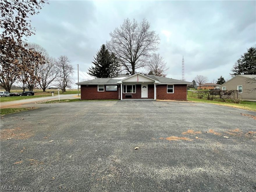 Brick Ranch with many options. The home has three bedrooms, one full bathroom, one half bathroom, living room, dining room, and an eat-in-kitchen on the first floor. There is a large covered patio off the kitchen in the rear of the home. The front of the home has a covered porch with recessed lighting. This home has lots of closet space. The master bedroom and half bath could be used for a home business since it has a dedicated entrance. The basement has walk-out bulkhead doors. The basement has a full bathroom, office, winter/outdoor clothes storage room, utility room, workshop, and lots of storage. There is a detached two-car garage that measures 26' x 22'. The home has two 200-amp breaker boxes and two-meter slots if you want to use the property for a business. There is a paved parking lot in the front of the home, a paved driveway on the side, and a gravel lot next to the garage.
