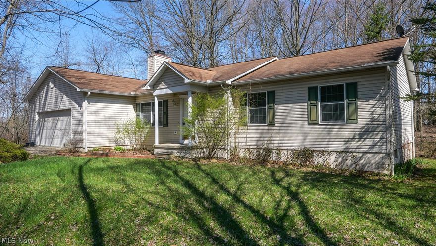 Rare find in Rootstown local school district - a true ranch on 2 acres! The home has two living spaces and a large eat in kitchen in the heart of the home. Main floor laundry is a huge plus. The primary bedroom has a large walk-in closet and attached bath. A large unfinished basement is perfect for storage. The privacy is unmatched while sitting on your large deck. Do not miss this one!