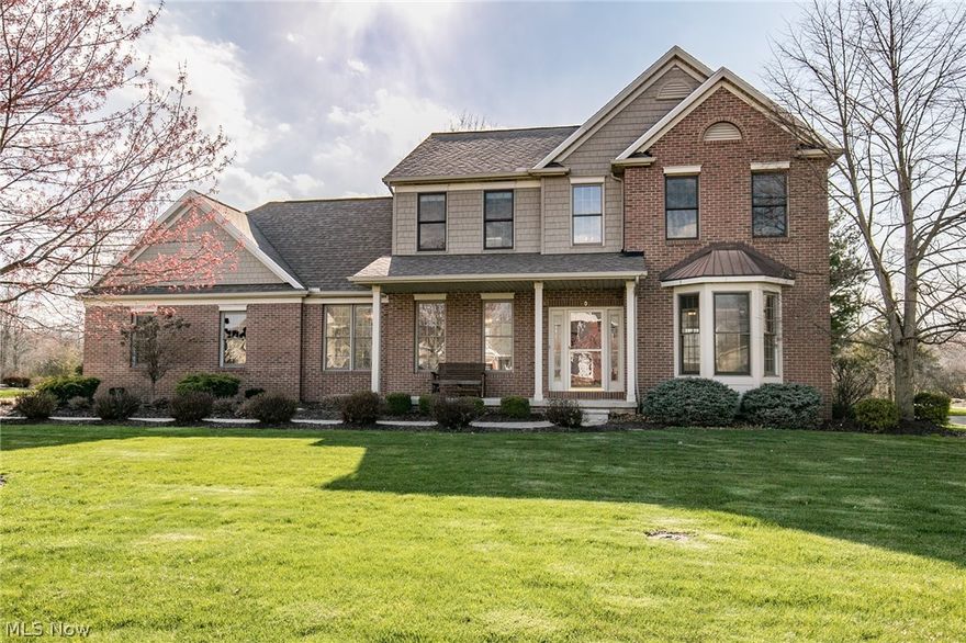 Curb appeal with wide front porch in the desirable Bridgeside neighborhood. A two story foyer welcomes you into this open concept home with 9 ft ceilings. Newly remodeled bathrooms include quartz-topped vanities (2020) and fresh paint throughout (2020). The eat-in white 
kitchen boasts an island and stainless Kitchen Aid appliances, granite counters, wood floors. Step through sliding doors to a park-like wooded lot with stamped patio ideal for entertaining. Family room with bay window and fireplace. Formal dining room for holiday gatherings. Master with vaulted ceiling. Full finished basement. 4 bdrms plus office. 1st floor laundry. Professionally landscaped. Irrigation system, security system. New roof/siding (2011),New A/C (2019),New Water Heater (2018), motorized awning (2014). This house is a rare find in a great neighborhood.
