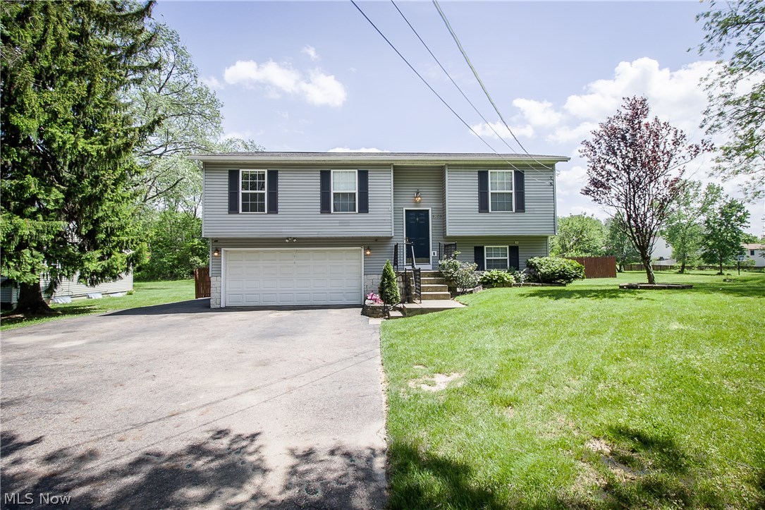 Meticulously kept and move in ready! You're going to want to see this wonderful home located minutes from Tallmadge, Chapel Hill Mall, and Goodyear Heights Metro Park! The main level offers a nice open floor plan with living room, dinette with access to the deck and kitchen with oak cabinets, laminate flooring, newer refrigerator, and dishwasher. Down the hall, you'll find all three bedrooms, each with double closets plus a full bath with updated vanity, ceramic tile floor, and skylight! The lower level features a rec room with Berber carpet, convenient half bath plus a utility room with laundry area and easy access to the 2 car garage. Your family and friends will love the fully fenced backyard wth deck, covered patio with 110 electric, 18' pool and playset! There's even a spot to park your boat or RV, plus the driveway is extra wide with additional parking beside the house. Updates include A/C 2003, asphalt drive 2005, tile in foyer & bathrooms & kitchen laminate 2007, roof 2008, water heater 2012, interior paint 2017 plus newer refrigerator & dishwasher- all dates approximate. This home has something for everyone!