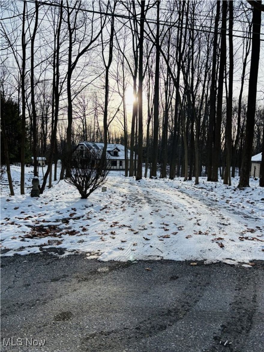 Nestled on a wooded 1.14 acre lot this single owner two-story Tudor offers the perfect blend of character and comfort. The home features beautiful woodwork and trim throughout the house and solid wood doors, a large living room with a cozy full brick wood burning fireplace, kitchen with spacious eating area - glass cabinets doors and kitchen desk, formal dining room with built in corner cabinets and beautiful glass sliding french doors that leads to the 4 season sun room off dinning room allows for extras seating or a peaceful place for your morning coffee overlooking the treed yard, first-floor office with builtin bookcase adds convenience for work or study, first-floor master suite complete with a full private bath with Jacuzzi tub, shower, double sink, walk in closet and plenty of storage and first floor laundry and half bath enhances everyday ease. Upstairs, 3 additional bedrooms with their own private full bathroom offer plenty of space for family or guests. Full, unfinished basement provides extra storage and room for your home gym or game room. 2 car attached garage with storage built in. This home features a whole home security system and radio intercom system, central vacuum, reverse osmosis water filtration system, Pella windows, Geothermal heating and cooling, leaf guard on gutters, radon remediation done in 2002, newer furnace, new septic system and new roof in 2025.  With its timeless Tudor architecture and tranquil wooded surroundings, this home combines classic style with modern livability. Schedule your private showing today.