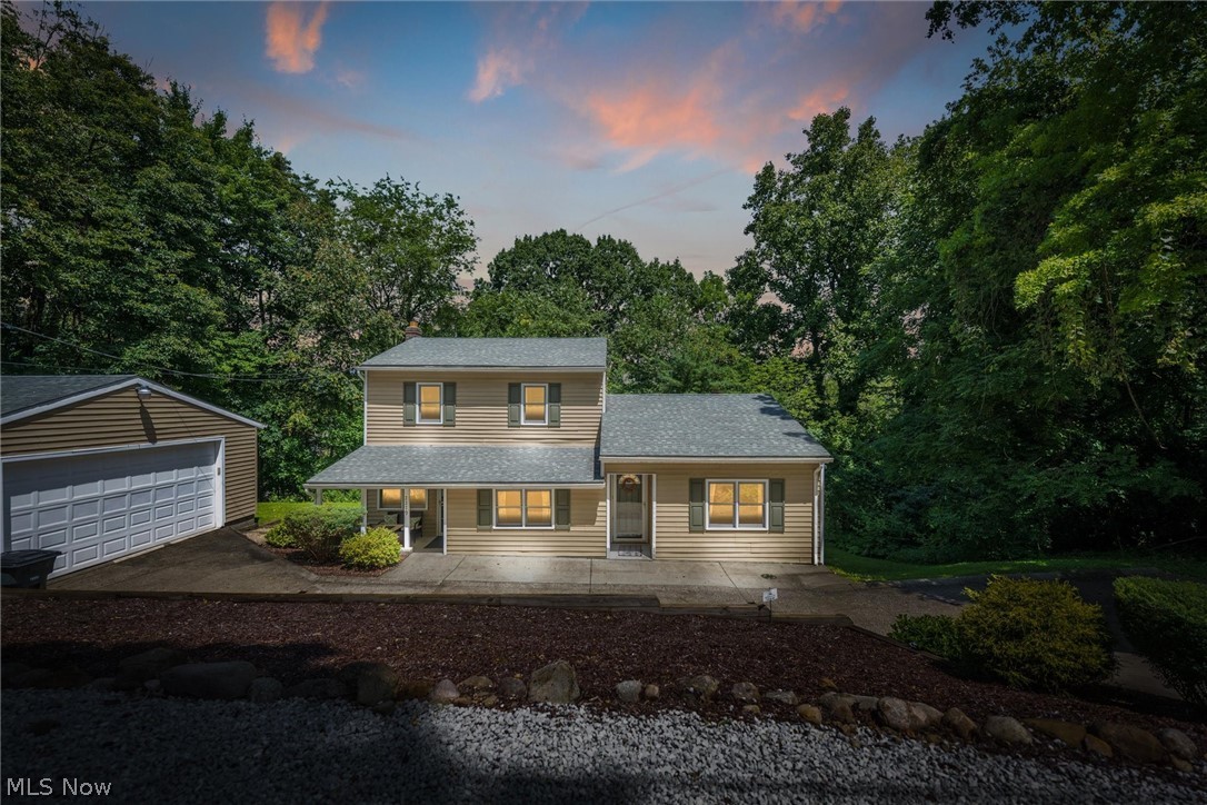 Welcome to this beautifully updated home in Ellet on a private lot! Through the front door is the spacious great room with soaring ceilings and a fireplace. Across the hall is the living room with access to a front porch through a secondary front door and the large backyard deck via french doors that flood the room with light. Large eat in kitchen with newer cabinets, countertops, appliances (2016) and flooring. A full bath rounds out the main level. Upstairs is the master bedroom, 2 additional bedrooms and a second full bath. Downstairs in the lower level is a finished recreation room perfect for entertaining or working out as well as a fourth bedroom. The other side of the lower level contains the laundry (washer and dryer 2016) and utilities. The private wooded backyard features a massive deck perfect for entertaining along with a large grassy area on the side for children and pets to play. Large two car garage, long driveway and abundant parking on a gravel pullout at the street fo
