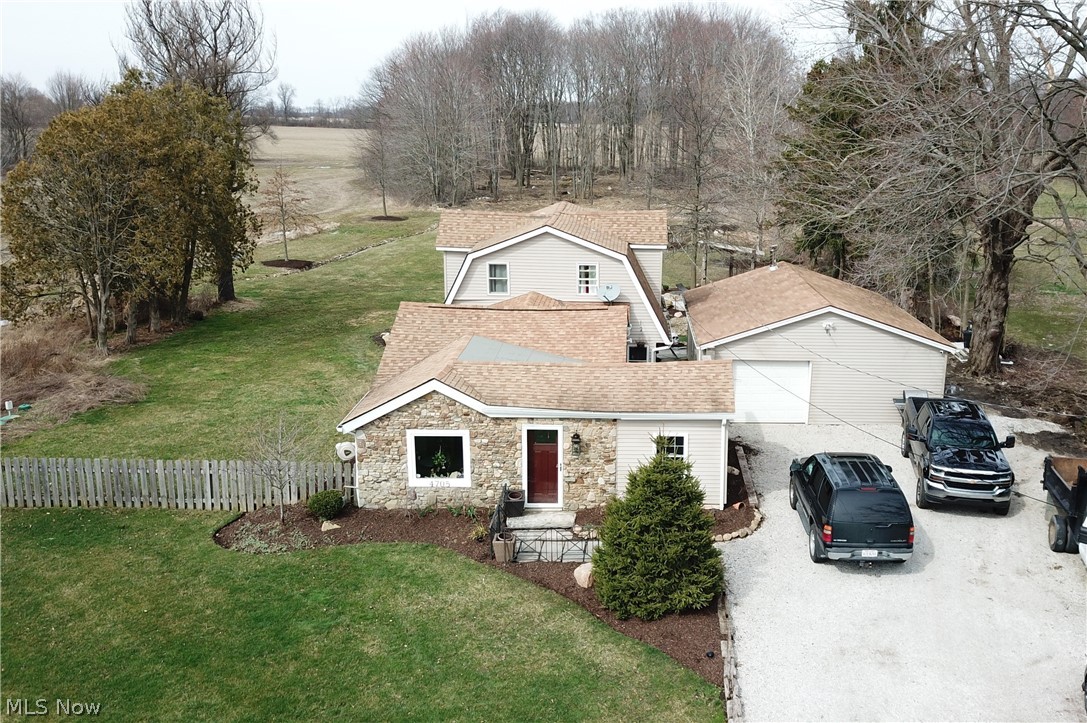 Welcome to 4705 State Route 303 in Ravenna! This three-bedroom, 2-bathroom home has numerous updates and beautiful features throughout. The recently updated eat-in kitchen has beautiful vinyl flooring, immaculate white cabinets that offer a ton of storage space, stainless steel appliances, and recessed lighting. The kitchen also has a fireplace! The spacious living room has vaulted ceilings and the same beautiful vinyl flooring as the kitchen. A bonus room is located off the living room – perfect spot for a craft room, play room, office – the options are endless! Master bedroom has a large, walk-in closet, as well as a recently updated bathroom. Sliding glass doors from the kitchen lead outside to the large, flagstone patio and beautifully landscaped, partially wooded backyard. Backyard has small putting green, two firepits, and a barn beam pergola – it’s a great spot to entertain! Some other updates include: freshly painted interior, windows, central heat furnace, water softener, wate