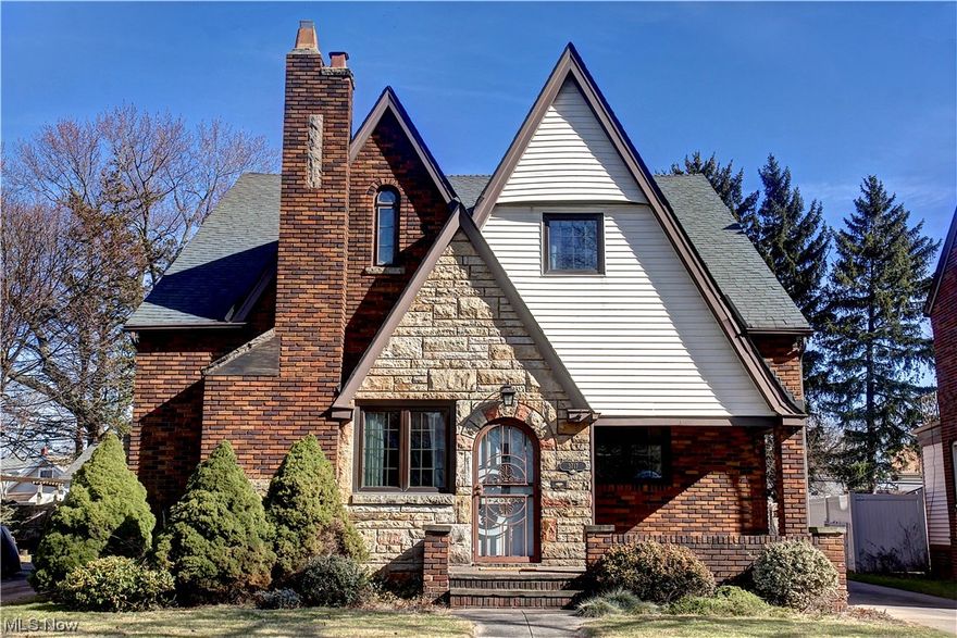 Introducing the quintessential Westpark gem! Nestled in the heart of the coveted Westpark neighborhood, this exquisite Tudor Revival home boasts 4 bedrooms, 2.5 baths, and a rich history. Originally crafted by the esteemed Scenic Building Company as a model home for the Merrimeade Heights subdivision, this residence exudes timeless elegance. Step inside to discover a meticulously maintained dwelling that pays homage to its historic roots. Adorned with original features, including gorgeous wood trim, hardwood floors, iron handrails and glass door knobs, this home exudes vintage charm. The spacious interior boasts lofty ceilings, built-ins, and captivating fireplaces, showcasing the craftsmanship of a bygone era. Entertain with ease in the expansive dining room, featuring original paneling and ample natural light. The well-appointed kitchen offers modern amenities, including stainless steel appliances and updated granite countertops, while retaining its classic allure. With a first-floor bedroom and full bath, this home offers both convenience and functionality. Ascend the dual staircases to find generously sized bedrooms and wide hallways, perfect for comfortable living. The lower level adds 690 square feet of finished space, with a cozy fireplace and ornate wood finishes, ideal for relaxation or recreation. Outside, a deep, fully fenced yard comes complete with a stone patio, pergola, and tranquil koi pond. Newer two-car garage built in 2012 is EV ready with dedicated 60amp 240v connection. Turnaround area back of house. ***Traffic lights on Lorain and Triskett are synchronized to ensure easy access in and out of driveway.***Close proximity to Warren Village and Kamm's Corner. Plus, enjoy easy reach to downtown Cleveland, Hopkins International Airport, Metroparks, and more. Don't miss your chance to own this remarkable Westpark residence, where historic charm meets modern comfort. Schedule your showing today and experience the allure of this exceptional property!