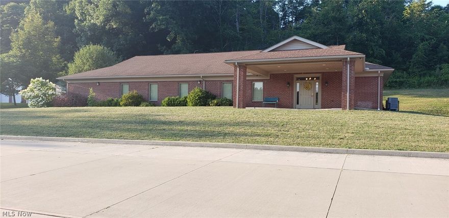 LOOK AT THIS INVESTMENT OPPORTUNITY!! This all brick BEAUTIFUL building has a covered valet pull through at entrance, perfect for many different business needs. Walk into the foyer with rich cherry milled woodwork for the perfect reception area. This building has a large mechanical room for plenty of storage. 2 LG Bathrooms with multiple stalls, handicap accessible, and with baby changing tables. 2 separate offices, 1 room is occupied by the Owner utilizing Your Kneaded Touch Massage and hoping to stay as a rental tenant. The other room is vacant equipped with sink and counter top. The large banquet area, has a stage and side rooms for hosting large party rentals or hosting other events. Currently a tenant is renting for dance classes each week and they are hoping to stay as well. Flooring in foyer, and bathrooms are ceramic tile, and commercial grade carpeting is throughout. This property has a gorgeous drive entrance off of the state highway and opens into a massive parking area. The