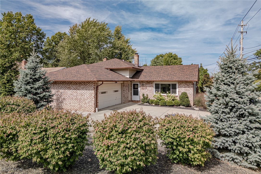 Welcome to 4669 Monticello Boulevard, a charming split-level home nestled on a corner lot in South Euclid. This residence offers 3 bedrooms, 2 bathrooms, and over 2,000 square feet of inviting living space. As you step through the front door, you're greeted by a bright living room featuring luxury vinyl plank flooring, fresh neutral paint, and an abundance of natural light. The living area flows effortlessly into the dining room and kitchen, creating an open and inviting atmosphere. The kitchen is equipped with granite countertops, tile flooring, a stylish tile backsplash, updated cabinetry, a full suite of appliances, and sliding door access to the covered back patio—perfect for outdoor entertaining. Descend to the family room, where a cozy brick wood-burning fireplace awaits, alongside a full bathroom and a convenient laundry/storage room. On the upper level, you'll find three bedrooms with newer carpeting and a full bathroom. The exterior offers a fully fenced backyard complete with a covered patio and an attached two-car garage, making this home a perfect blend of comfort and style.
