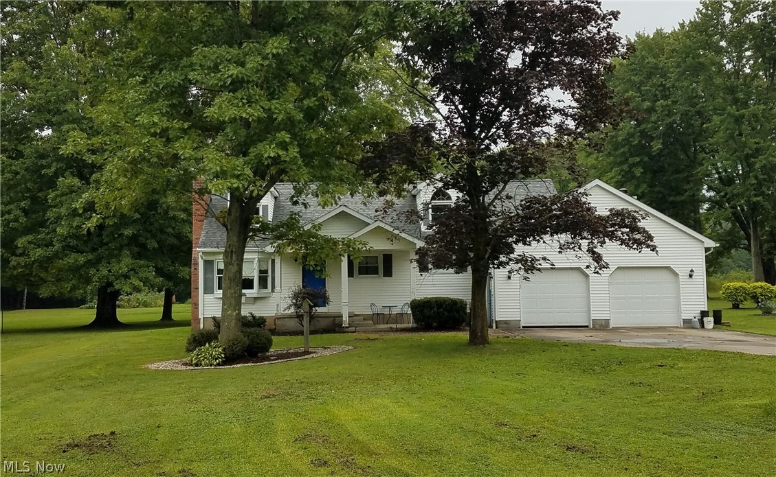 Peaceful setting with room to grow. Located in Braceville Township just minutes from the Turnpike, this 1-1/2 story home on an acre lot awaits. From the covered front porch,you enter the living room with plenty of natural light from the bay and double-hung windows. From there, enter the eat-in kitchen with newer cabinets, counter and all appliances. Follow through to a large family room with gas fireplace and sliders to the deck, or step into the garage or down the basement steps. Back through the kitchen, you'll find the staircase to the huge second floor (which could serve as a third bedroom with some finishing touches) and the hallway to two big bedrooms and full bath on the first floor. A second full bath is located near the laundry area in the basement. The oversized garage is attached to the house and a separate garage with covered patio provides space for your hobbies and a place to relax and enjoy the nature. Well water supplies the house; with a tie-in to city water a
