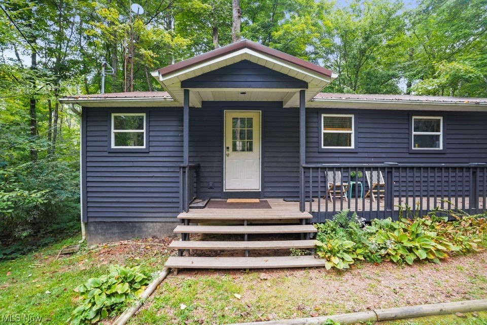 Welcome to ZigZag Point, a completely turn-key and income-producing cabin in the world famous Hocking Hills. Nestled on a private wooded lot, this completely re-envisioned cabin has been artfully designed to stand out from the crowd. With 2 bedrooms and 2 full baths, plus open concept living room + kitchen + dining, this cabin will accommodate families and couples alike. The outdoor space provides the true Hocking Hills experience with a hot tub and firepit, surrounded by views of only trees. There is an additional detached 2-car garage for storage or to add additional living space. Perfect location, just minutes to Ash Cave, Old Man's Cave, and the many other outdoor activities the Hocking Hills have to offer!