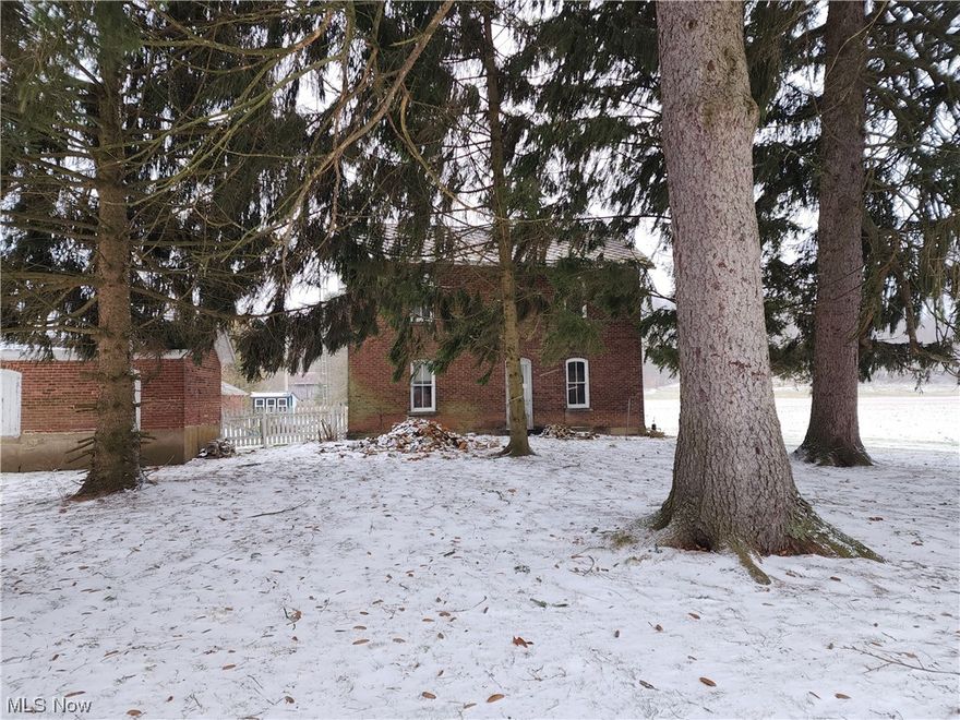 Charming 1890 brick house with character, awaiting your personal touch through renovation.  this 2 acre property boasts a historic barn and smokehouse, outbuildings for livestock, and fenced area.  It has a 2-car over sized heated garage (28x32), free gas to the home and garage, updated service, septic was replaced in 2022.  Garage furnace is newer, house furnace approx. 1987.  An added bonus is the lot crosses the road to give river frontage.  Don't wait for this project home to disappear.