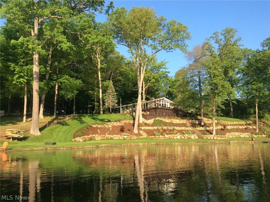 Beautiful Rex Lake, lakefront home for sale. Completely remodeled in 2012 with new kitchen, granite, stainless appliances, bathrooms, roof, siding, windows, doors, furnace, A/C, tankless water heater, electric/plumbing, flooring. Walk-out finished basement with 42' x 8'6" screened-in room. Two fireplaces, two decks for entertaining, totaling 1,500 sq. ft. 1st Floor laundry, mud room. Lot contains 250’ of lakefront with new stone seawall and two sand beaches, irrigation, stone fire pit and kayaks.