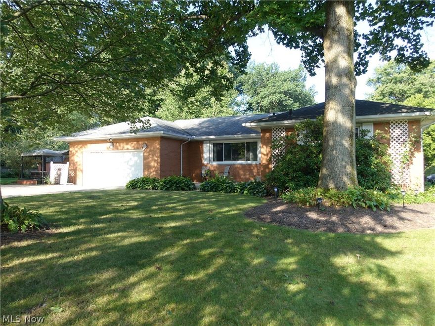 Spacious all brick ranch in Tallmadge!  Lovely property features spacious living room with gas fireplace, crown molding & recessed lighting.  The dining room also has crown molding and is open to the living room so it is perfect for entertaining.   All bedrooms have hardwood flooring and nice closet space.  The master offers an updated full bath with walk in shower (2016).  A second full bath features double vanity and jetted tub.  The applianced kitchen provides for plenty of cabinet and counter space, recessed lighting & has a pantry with pull out drawers.  There's a nice sunroom with lots of windows for natural light and access to the side patio and beautiful yard.  The lower level is amazing and offers a recreation room, separate room perfect for an office/bonus room plus a full bath with walk in shower AND has glass block windows.  You will love the outside to relax by the fire pit, and side patio.  Some updates include: Furnace/AC - 2014; windows - 2006; roof - 2001 (35 yr shingl