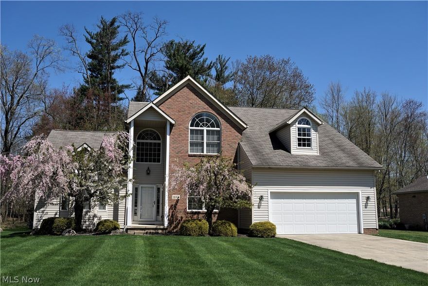 Amazing opportunity in Kiowa Estates in Tallmadge.  Perfectly located private setting near modern school campuses, newly constructed athletic facilities, and Tallmadge Rec Center. This contemporary colonial has a distinct 2,632 sq. ft. layout. featuring an open floor plan. Uniquely designed vaulted ceilings grace Family Room, Master Bedroom and Entry. Enter home onto magnificent hardwood floors, light pours through large circle top window that highlights two-story entryway. Entry walks directly into massive Family Room; giant picture windows with custom blinds flank stylish gas fireplace. Hardwood flooring flows into sizable eat-in kitchen which connects conveniently to Family Room and has a walk-out to deck. This space is perfect for entertaining. Just off entry, spectacular Master Suite has extraordinary character. Oversized windows and architectural ceiling design make Master Bedroom voluminous. Spacious en suite sports dual vanities, corner garden tub, walk-in shower and generously