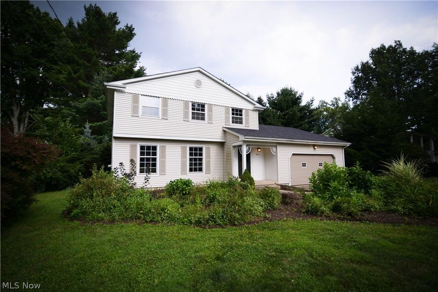 Peace, serenity, and Canfield school systems! This enormous family home is situated on a little over an acre of private land, close to all shopping, public transportation and major freeways, but tucked away in the privacy of your acre lot. It's like country living in the city...and there's even a barn! 4 bedrooms on second floor all boast beautiful hardwood floors and large closets. The bathroom has beautiful ceramic tile and is so clean it looks like the day it was installed. Tons of storage and built ins in the hallway for all linens, products and anything else you may have. First floor has a beautiful, large living room and foyer with coat closet, enormous eat-in kitchen and sunken family room with the coziest stone fireplace you can imagine and charming exposed ceiling beams. Sliding doors lead out to your patio and backyard oasis. Mature landscaping and a large barn. Attached 2 car garage has electric, shelving, water, and attic access for even more storage. This home can't wait f