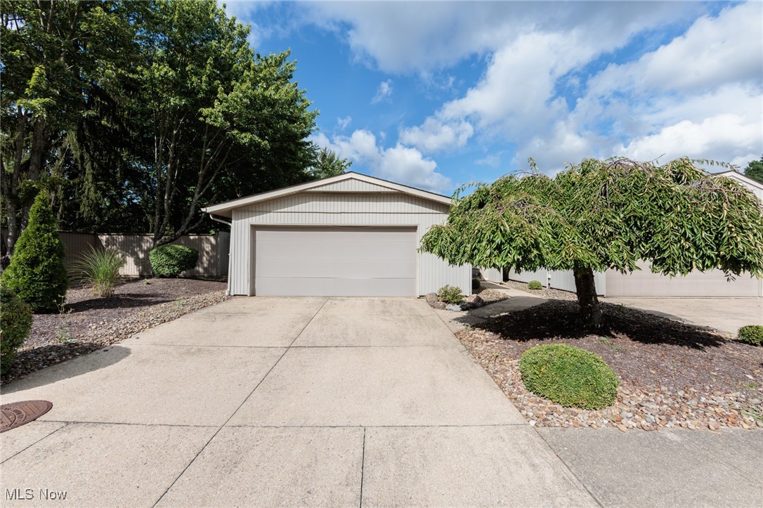 Situated on a cul-de-sac street within Strongsville's Meadowood community, this end unit, 2 bedroom, 2 bath vinyl sided Ranch cluster home offers the perfect blend of comfort and convenience near additional parking and mailboxes. Step inside the spacious, open-concept layout is anchored by a light-filled great room with a cozy brick fireplace with built-ins & dining area, perfect for relaxing or entertaining guests. The eat-in kitchen has plenty of cabinetry, ample prep space, pantry storage, desk area and included appliances, offering a welcoming space to cook and gather. You will appreciate the nice neutral paint & new plush carpeting. Both bedrooms are generously sized, including a primary suite with a large walk-in closet and an private bath w/ a walk-in shower & double sink vanity. A 2nd full bath & 2nd bedroom adds flexibility, whether you’re accommodating guests or needing a home office space. A dedicated laundry room w/ washer, dryer, utility tub & storage; plus convenient access out to the private courtyard. More storage is found in the 2 car attached garage & a workshop area. Outside, enjoy your own private, fenced-in courtyard with a patio ideal for morning coffee, grilling, or a quiet evening retreat. New Hot Water Tank(2023). 1 year home warranty provided. Set in a low-maintenance neighborhood where landscaping and snow removal are taken care of, this home lets you enjoy more time doing what you love. As part of the Meadowood community, you’ll also have access to amenities like a clubhouse, pool, tennis courts, and playground. Conveniently located near shopping, dining, and major highways. Welcome Home!