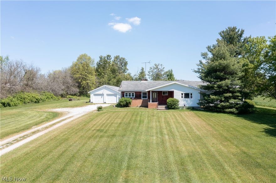 Check out this charming home with an in-law suite! 5 acres of land and a very large working garage make it a perfect home if you have lots to store. The deck out back overlooks beautiful land and the fireplace makes it nice and cozy for those cold winter nights. 3 bedrooms, 3 bathrooms, 2 kitchens and tons of living space are on the entire main level along with the laundry room. Come in and take a look!  Home can be separated in two or used as one big house!  Home needs new kitchen floor.