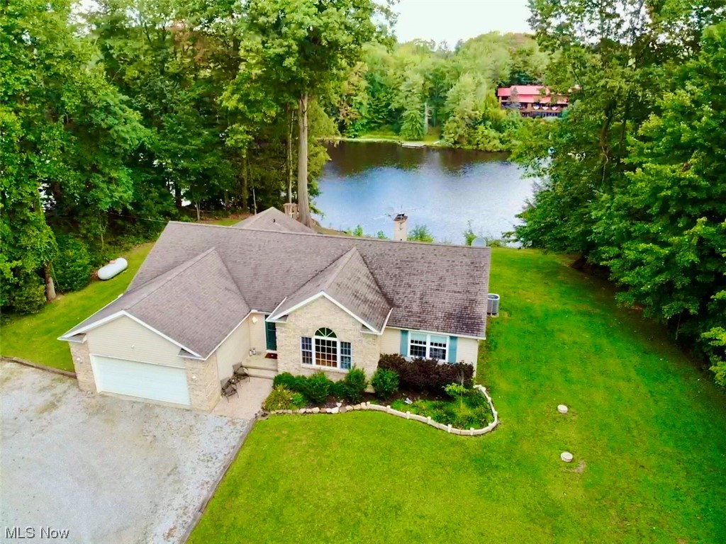 Welcome to this one of a kind Lake front Ranch sitting on over 5 acres of land!! Look no further! This updated Ranch has it all! Kitchen is equipped with stainless appliances, granite counter tops, farmhouse style sink, tile backsplash and breakfast far. The huge Great room has vaulted ceilings and a gas fireplace. You also have a Dining room or could be an office on the first floor. The Primary bedroom is also large and has its own private en-suite with dual sinks, granite counter tops, air jet tub, tiled shower and walk in closet. Two other generously sized guest bedrooms along with another full bath updated with granite counter tops and tiled tub. Lastly, on the first floor is the laundry room with a personal dog washing station. In the lower level you have a enormous Rec room, perfect for entertaining. And two other large areas for storage. Outside is the dream! Not only do you have a private patio off the Kitchen but you have your own private dock leading to the 70+/- acre lake!!!