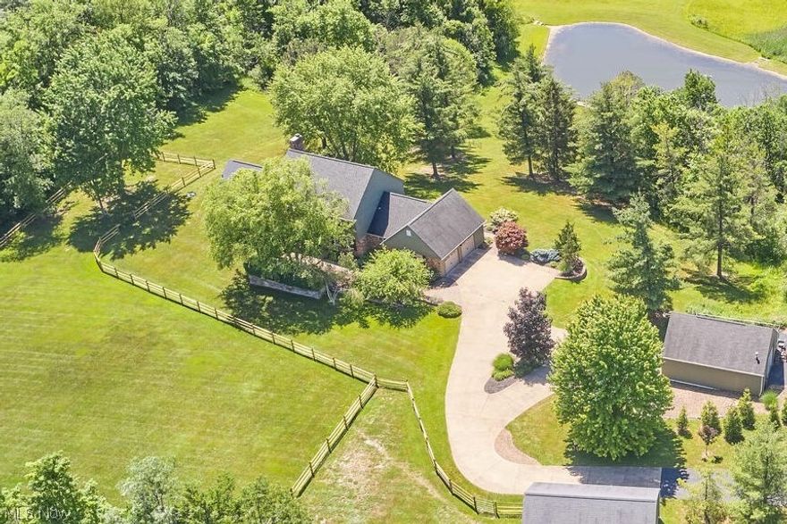 Fabulous, custom built, one owner home situated on 8 picturesque acres presents an idyllic country setting.  This impeccably maintained colonial boasts new Amish built cherry kitchen that opens to engaging family room.  Formal dining room. Den, guest bath, and laundry room conveniently located.  Owners added a luxurious FF master bedroom suite featuring h/h closets, glamour bath w/bubbler tub and heated floors, and access to outdoor patio.  Three generous sized bedrooms including a second master bedroom w/en-suite bath and jacuzzi tub, and main full bath complete the second floor.  Partially finished lower level offers stairs to garage.  Extensive landscape highlights barn stone walls and paver brick patio.  Two heated outbuilding(s) including barn which supplies water.  Newly fenced paddock for animals.  Screened in gazebo and Azek deck overlooks grounds and offers scenic views of pond.  Gas well currently provides free gas to home and outbuildings.  Ideal horse/farm animal property.