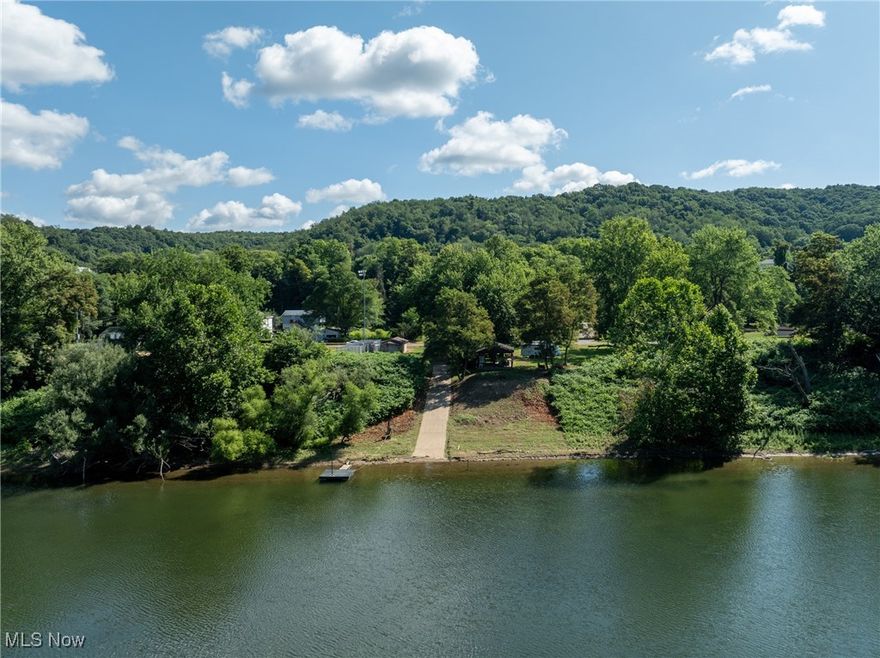 This exceptional riverfront property features 70 feet of prime frontage on the Ohio River, complete with a private concrete boat ramp and dock. With two cleared lots providing ample space and stunning river views, this rare find is perfect for those seeking a serene retreat or a vibrant entertainment spot. At the heart of this property is a spacious pavilion, fully furnished with outdoor furniture, a refrigerator, and a grill, ideal for hosting gatherings. The pavilion also boasts brand-new electrical work, ensuring you have modern amenities at your fingertips. Two well-maintained sheds offer abundant storage for all your outdoor gear, tools, and equipment, keeping everything organized and easily accessible. For added convenience and comfort, the property includes a 2011 Heartland Edge camper, perfect for weekend getaways or extended stays. Don't miss out on this unique opportunity. Call your agent to schedule a showing today and make this stunning riverfront property your own!