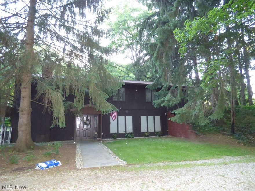 Nature Lovers wooded property with private setting and three stocked ponds, one is a koi pond  Deck around three sides of property on upper level allows you to relax and enjoy nature.  Main living on second floor.  First floor has kitchen, living area and bedroom/ recreation room or office, could be used as in-law or teenager suite.  Garage is 26 x 40 with second floor with full bath and furnace.  Also included 24 x 24 pole barn and storage shed.  New septic, furnace and AC in 2017.  Roof approximately 3 years old.  Many possibilities with this property.