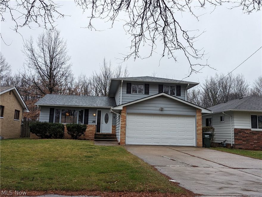 Warrensville Heights split-level with attached garage!!! Newer roof!!! Newer furnace!!! Newer hot water tank!!! Three bedrooms!!! 1.5 baths!!! Excellent location!!! Very nice kitchen with island with many updates including quartz countertops, glass backsplash, ceramic flooring, & island with butcher block countertop!!! Half bath/laundry room/large closet and utility room on the 1st floor!!! Garage door opener!!! Lots of closet space!!! Home warranty!!! Easy to show!!!