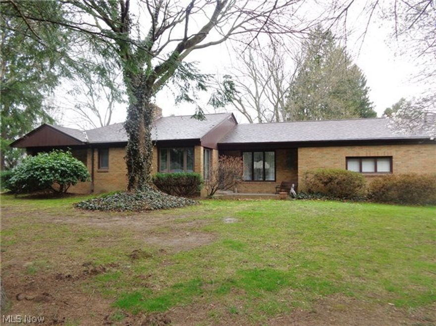 Solid well maintained Brick Ranch with 3 Bedrooms, 2.5 Baths. Nice private setting on .61 acre directly across the street from the Tuscarawas River (no flood insurance required). Very secluded. First floor Master Bedroom includes Master Bath. Spacious updated eat in Kitchen with large pantry. Living Room boasts a beautiful brick fireplace. Full Basement with a Rec Room, Fireplace, Workshop, Craft Room and shower. Lots of updates to include Shingles-2010, remodeled Bath-2010, vinyl windows, new water pump-2008, new rented hot water tank-2013. 2 Car (19x24) Garage with water and 220 amp electric. Lots of storage throughout. Definite  must see! Don't miss out on this move in ready home!