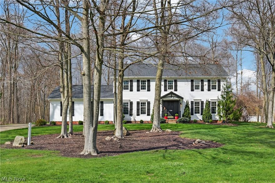 Move right in and enjoy this beautifully updated 4-bedroom, 3 bath home in the desirable Woods of Western Reserve — minutes from downtown Hudson's shops, restaurants, and the highly acclaimed Hudson City School District. The two-story foyer makes a great first impression with plenty of natural light. The kitchen is set up for everyday life and entertaining with a large island, built-in beverage fridge, and plenty of seating. Updated in 2022 with new countertops and sink, and in 2024 all new appliances were added including a refrigerator, double wall ovens, dishwasher, and range. The kitchen opens into the cozy family room with a wood-burning fireplace — a space that's easy to gather in. Off the family room you'll find a versatile space that works perfectly as a home office or sitting room. The dining room, steps from the kitchen, works equally well for casual dinners or larger gatherings. A large mudroom rounds out the first floor with plenty of space for coats, backpacks, and everyday essentials. Upstairs, brand-new carpet runs throughout. The primary suite is a spacious and comfortable escape with his-and-hers closets and a beautifully updated bath featuring a double vanity and tiled shower. The three additional bedrooms are well-sized and work great for family, guests, or a home office. The finished basement adds flexibility for a rec room, gym, playroom, or extra bedroom. The screened-in porch opens to a deck overlooking a stunning pool and professionally landscaped yard — an incredible outdoor setup made for summer entertaining. The inground heated pool features the Healthmore Pool Management System, reducing the need for traditional chemicals. The 2.5 car garage includes new garage doors and opener, plus a workshop with a built-in workbench. Major updates include a new roof and siding in 2019, A/C in 2020, and hot water heater in 2021. Fresh paint throughout much of the home was completed in 2026. Truly move-in ready.