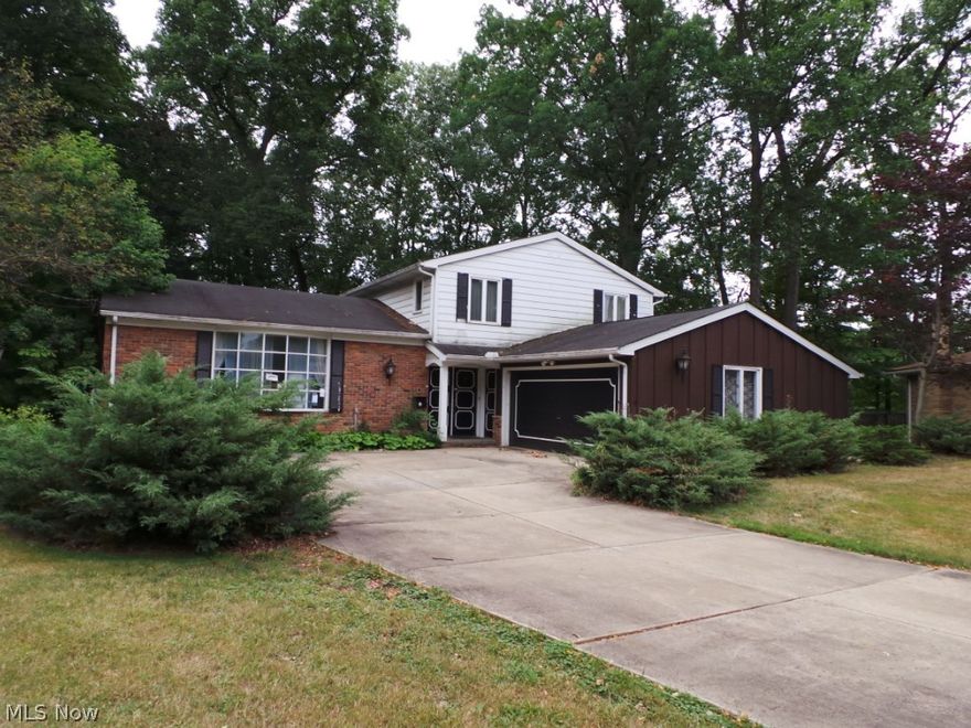 Spacious split with large parklike backyard.  Living room, dining room, kitchen on main level.  Family room on lower level.  Separate basement w/laundry area.  Upper level has three large bedrooms.  Property has lots of potential!  Sold AS IS.