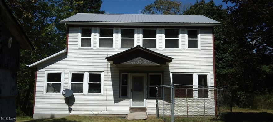 Rehab Opportunity is knocking! ************Come see this absolutely nostalgic home nestled on 5 acres of scenic solitude. This property is an open canvas of opportunity to paint your picture perfect palace. There is an open floor plan on all three levels of the home. Newer block foundation, windows, siding, metal roof, beams and more. If you have thought about building, come see this one first! This can be a 5 bedroom 2 bath . There is an 8‘2“ garage entrance that can be used to put a garage door on and you can drive right into the basement.