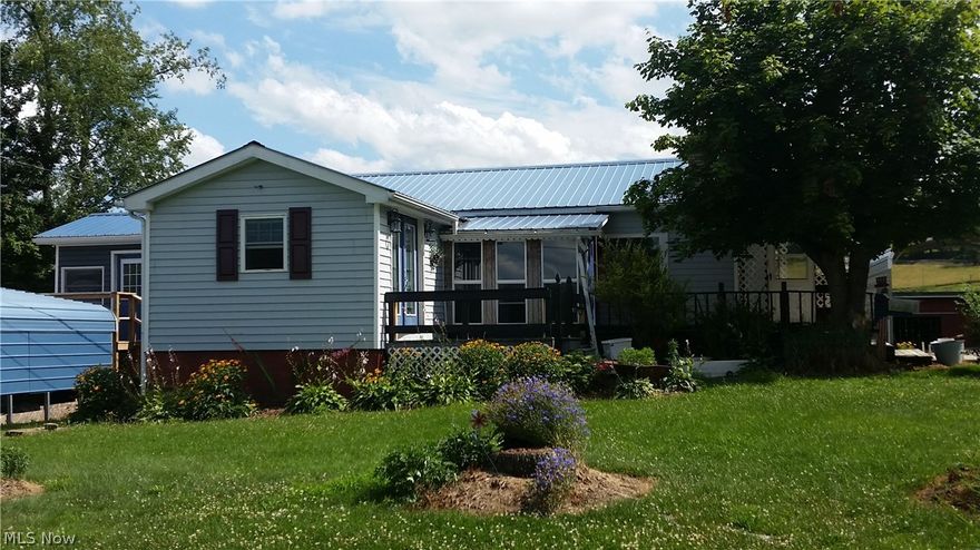 Nicely kept 3 bedroom home on almost an acre.  This home features a nice kitchen, laminate flooring, and a cute sun room perfect for your flowers.  The outside features many buildings such as a 2 car garage with workshop in the back complete with electric and heat.  There is also a one car detached garage and two , 2-car carports. There is a barn/shed at the back of the property with heat also.  This property also has a beautiful, flat extra lot with lots of potential.  A/C and furnace 2012, newer metal roof (per owner).  Partially finished basement with kitchen including oven, refrigerator and dishwasher.  A MUST SEE!