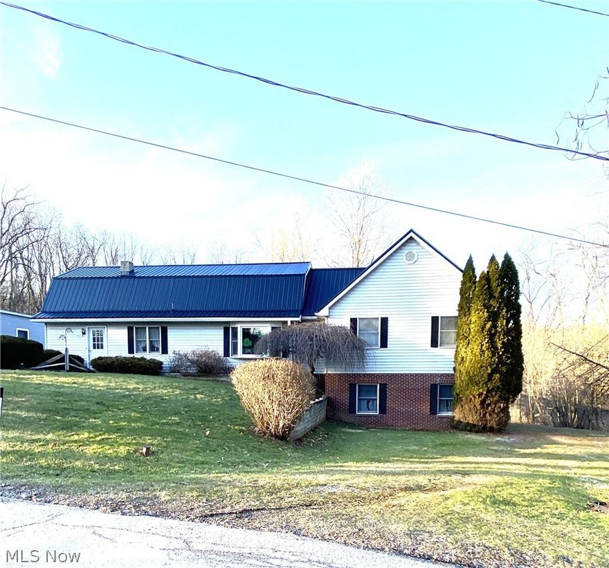 East Palestine, OH - Located in a quiet neighborhood within the Village of East Palestine is where you will find this spacious 4 bedroom, 2 bath Dutch Colonial home. This home is over 2000 square feet and offers privacy, space to spread out and an abundance of storage! The first floor offers an entry way, eat in kitchen, living room , dining room, full bath, small bedroom that currently is used as a play room and a 23 x 22 family room! The second floor boast the primary bedroom, a large open space listed as study and 2 additional roomy bedrooms. A stand out feature is the garage space this home offers. There is an over sized 2 car detached garage with a small office, a 2 car integral garage located in the walk out basement and another detached garage with workshop. These garage spaces make it ideal for hobbyists, mechanics or anyone who desires storage space. Another feature this large home offers is tons of useable outdoor space highlighted by a 2025 above ground pool!  Once you become the next owner of this sizeable property you will be able to sit on the rear patio or deck and enjoy privacy and natures scenery. The second bath is located in the basement and offers a toilet and shower. East Palestine is located on the OH/PA state line approximately 25 minutes from Youngstown, OH, 1 hour from Pittsburgh, PA, 40 minutes from Pittsburgh International Airport and 1.5 hours from Cleveland, OH.