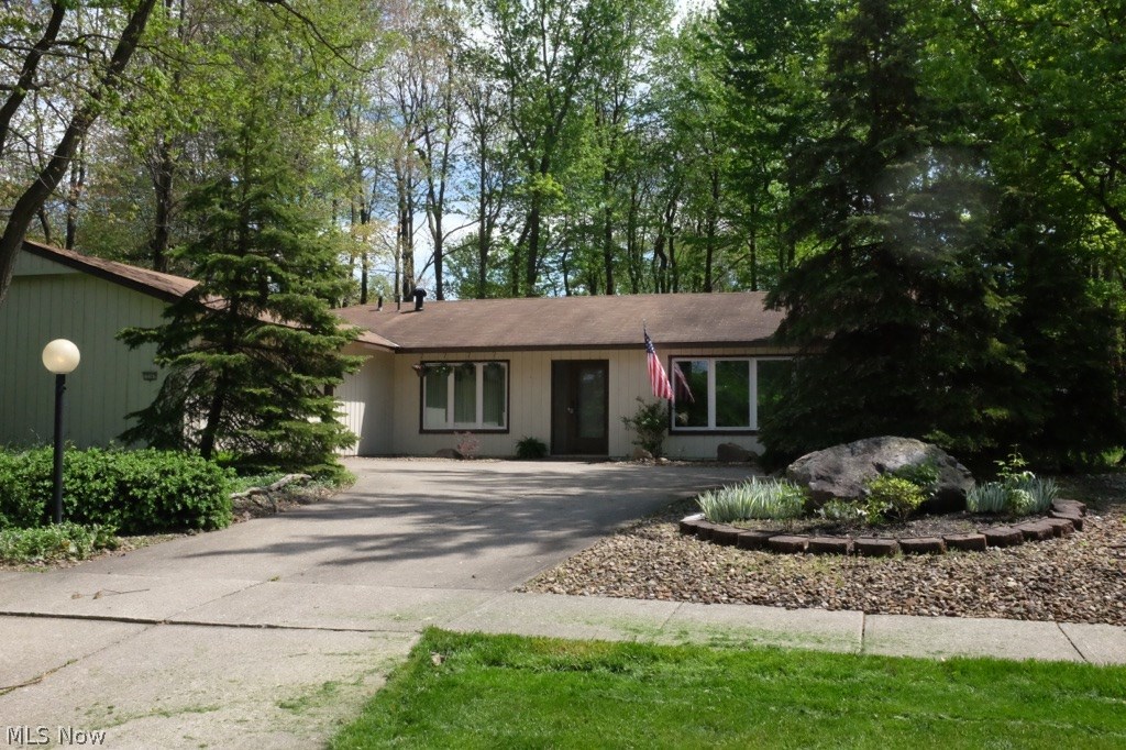 Dont miss this exceptional ranch in the desirable Ledgewood neighborhood. This bright, clean and light filled home seamlessly blends the nature inspired architecture of Bob Schmitt seen throughout the neighborhood, with modern finishes and functionality. High end upgrades include new flooring in nearly every room, new appliances, and fresh, modern paint colors throughout. Many new windows as well as new sliders out to the fully fenced back yard offering mature shade trees and perennial landscaping. The open floor plan lends itself to a variety of uses of space. Walk in to the foyer with its original slate flooring, past the formal dining room (currently used as a perfect office space), into the great room with a charming fireplace and walls of windows including a new slider to the serene back yard. Off the great room you will find an eat in kitchen, with a huge pantry and a slider to the patio. Down the hall is the guest bath as well as a laundry/mud room with great storage, attac