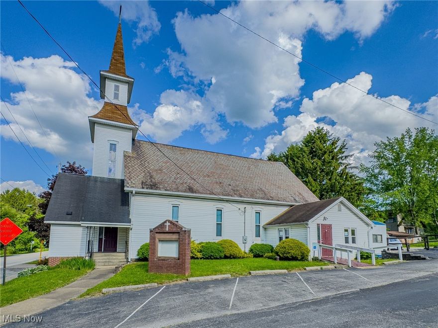 This spacious former worship center in the heart of Rogers, just minutes from Rt. 7, offers a remarkable opportunity for those seeking a large, versatile space with small-town and historical charm. With over 2,000 sq ft on the main level and more than 1,800 finished sq ft on the lower level, the layout provides incredible flexibility. The upper floor features a generous sanctuary area that can comfortably seat over 170 guests, a small private office space with storage, a foyer, and two restrooms. A unique highlight is the classic bell tower, complete with a functioning bell that adds character and history to the property. The lower level is ideal for hosting events, sizable gatherings, or community programs, boasting an expansive fellowship hall and a fully operational kitchen equipped for banquets or large-scale meals. A utility room and a multi-use flex space offer additional functionality—perfect for a classroom, office, or breakout room. Outdoors, the property features a beautiful slate roof, a 16'x10' storage shed, and an office trailer that expands your usable space. The sale also includes a 0.17-acre vacant lot located directly behind the building (Church St. runs in between)—an excellent option for expanding the parking area or future development. The main property already includes 14 dedicated parking spaces, along with a designated handicap spot and an accessibility ramp for easy entry. Located just TWO minutes from Rogers Flea Market—the largest weekly open-air market in the tri-state area—this building benefits from both visibility and local traffic. Whether you're envisioning a business, event venue, community center, or something entirely new, this property provides the square footage, infrastructure, and location to make it happen.