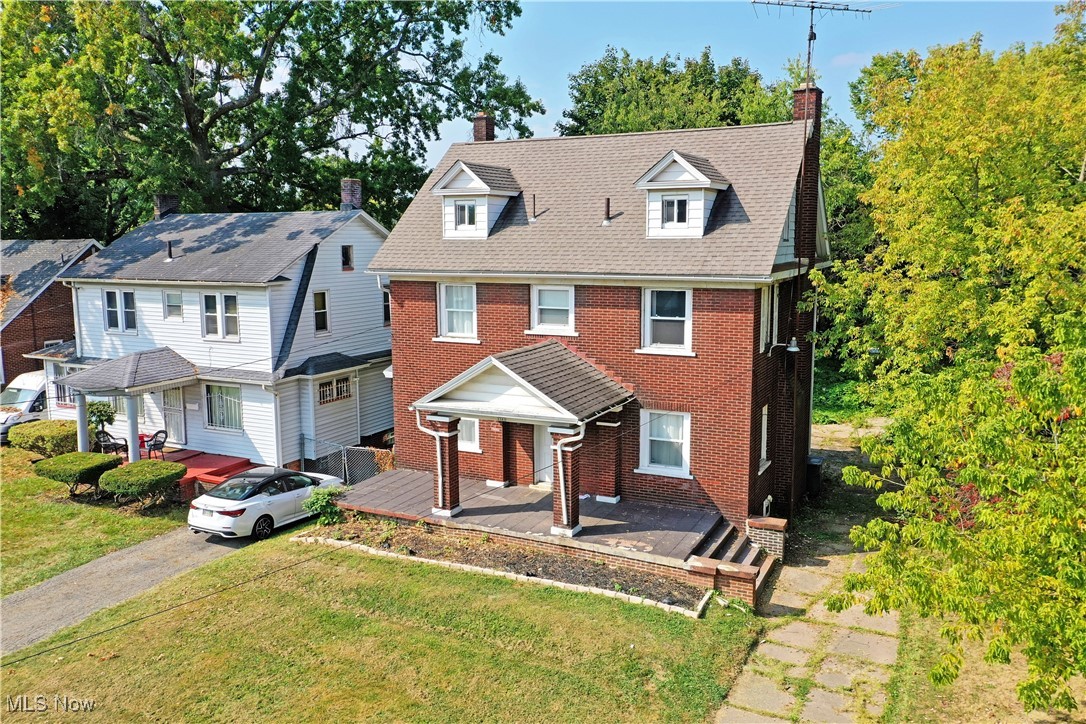 With its six available bedrooms that span three floors of finished living space, this impressively spacious Youngstown residence packs a big punch! Offering up an all-brick construction, the handsome exterior delights with its durable, lasting appearance that’s paired with an expansive front patio and covered entryway. The cement driveway allows for an easy garage addition if needed behind the home. Located near the historic districts, these desirable locations put you at quick reach of nearby attractions. Inside, welcoming, move-in-ready living space branches from the prominent foyer. A deep-set living room includes a stone-lined fireplace and built-in storage while the formal dining room is located opposite the entrance and main staircase. An inviting kitchen employs modern, stainless appliances and stained wood countertops that complement the ash-colored flooring. Four welcoming bedrooms branch from the second-floor landing, each with large windows and personal closet space. A full bath completes the floor with its stylish vanity. Up to the third floor, two additional loft bedrooms each flank a potential packed half bath. Laundry service and utilities are located at the basement level.