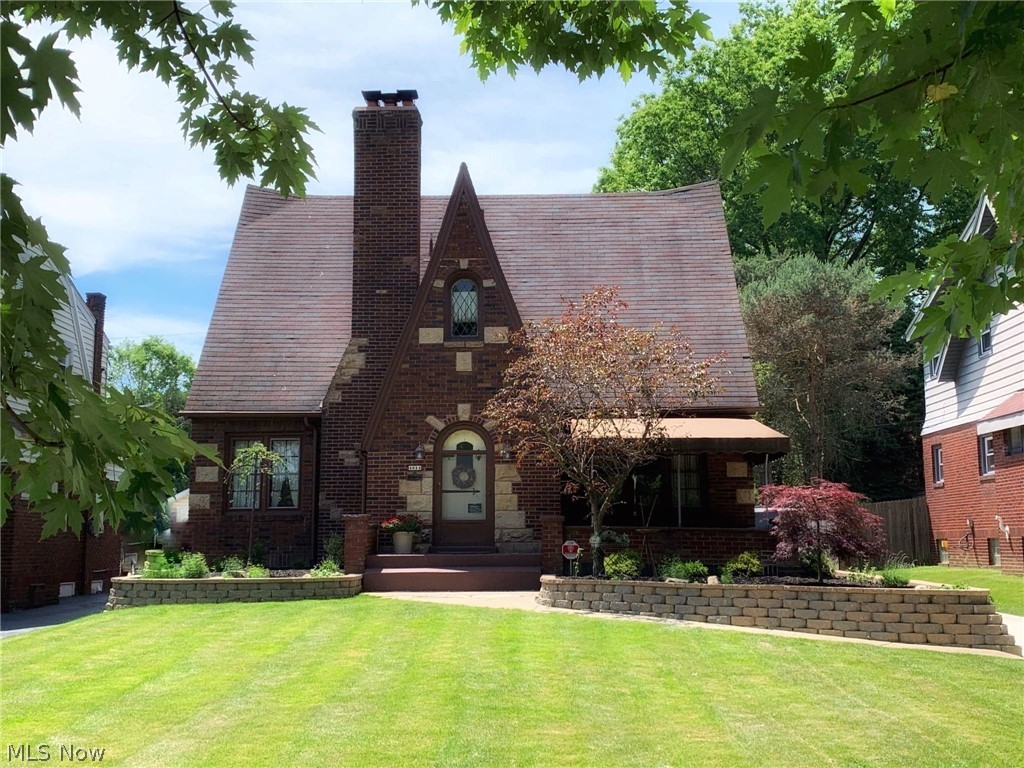 Watch the seasons unfold from this beautiful solid brick Tudor overlooking the lamp-lined boulevard! Turn-key and lovingly restored to its original beauty while maintaining it's character, this 1643 SF home with gorgeous refinished hardwood floors throughout, tastefully updated kitchen,spacious open living room and formal dining room and first floor bedroom and half bath! Upstairs you'll find 2 spacious bedrooms and an amazing full bathroom with tumblestone around the shower! (You'll love it)! The old boiler heat was replaced with 90% gas forced air and central air! All new windows except for front are new. The front windows were re-glazed instead of replaced to maintain the original beauty. There is a roof top patio off of the second floor over the garage, which had the roof replaced! Covered front porch w/3 year old awning. New driveway. Professionally landscaped! This is a 'must see'! PLEASE FOLLOW COVID-19 GUIDELINES!