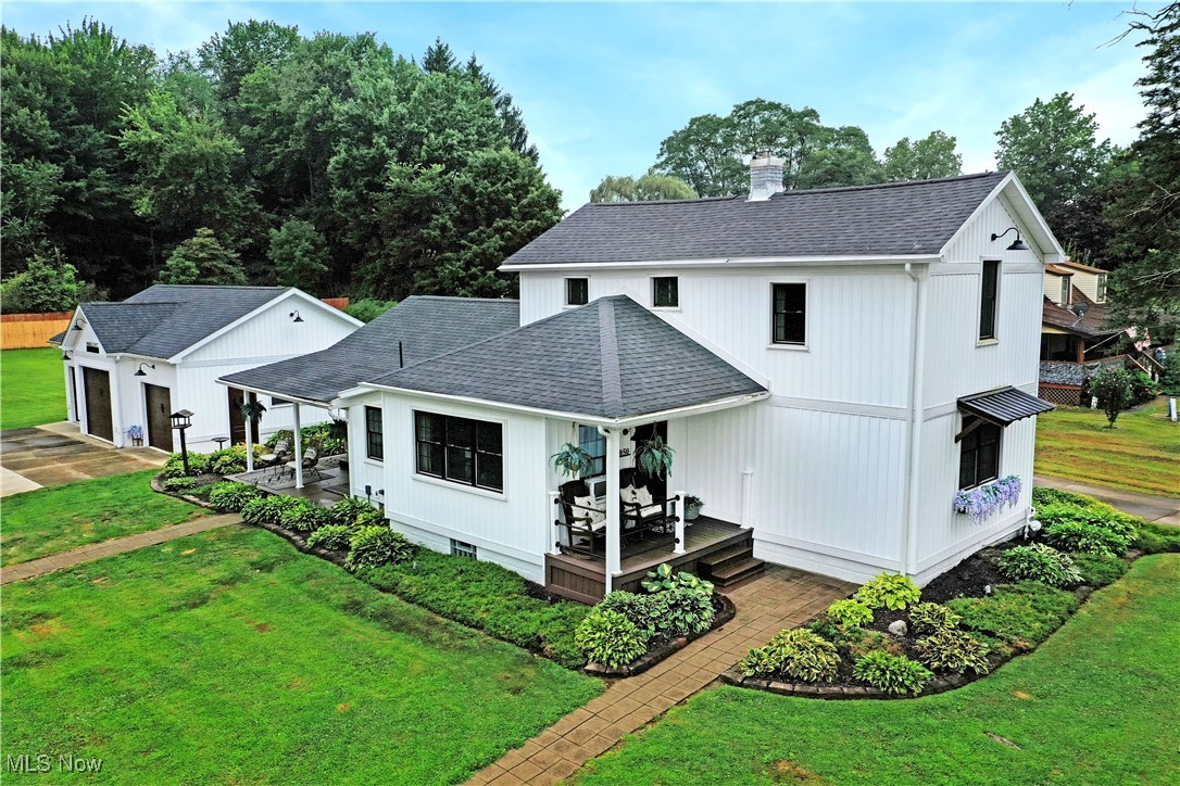 Is it really true? Can you really find perfected Farmhouse styling right in your own backyard? It’s real, and there’s more than you could ever imagine. Welcome home to this stunning Vienna estate, ready to excite with stunning good looks and sleek exterior features that’s sure to have you falling in love! The prominent residence is an immediate attention seeker, instantly captivating with its bold, white and gray exterior. Black window frames add a modern touch as the warm, stained wood styled garage doors circle back with natural warmth. Two covered patios are wrapped in lush landscaping with a basement walk-out leading through the larger garden. A triple bay garage handles all your storage while a second outbuilding provides additional equipment storage – easily converted to a backyard bar or lounge just the same. We’re not done yet though, a pergola awning awaits in a rock garden beneath the shade of a flowering tree, an excellent backyard getaway. Step inside to immerse yourself in cultured style, focusing on soft lighting and rustic attributes. The expansive, great room highlights decorative lighting in the dining portion as sunshine spills through the lattice windows opposite the room. A must-see master bedroom steals away nearby. Meanwhile a gracious kitchen blends stainless accents and appliances with faux brick trim and distressed, hardwood styled flooring. The adjoining full bath offers a basin sink and modern glass door shower. First floor laundry adds to the appeal, opposite the foyer. Upstairs, a pair of additional bedrooms bring sizeable footprints and great looks.