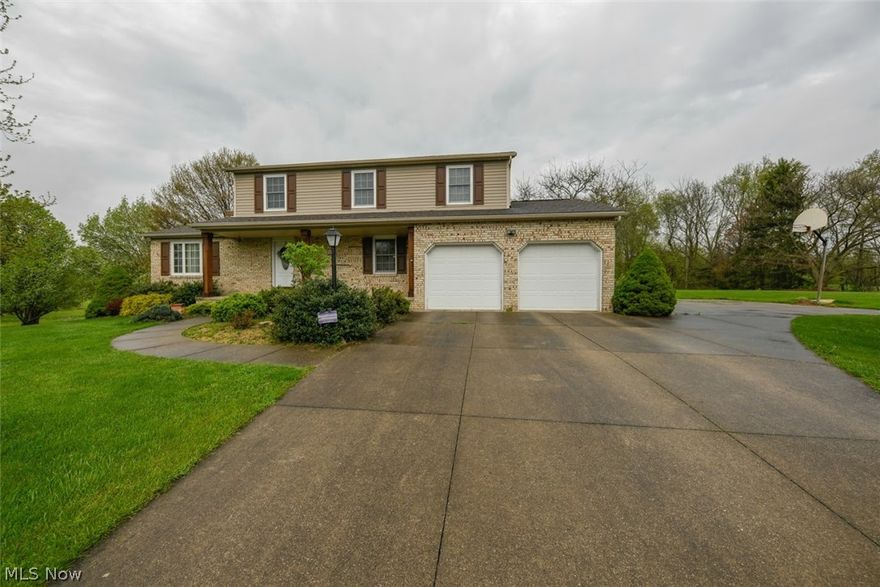 Welcome home to this gorgeous 4 bedroom, 2.5 bathroom beauty! Gleaming hard wood flooring! Living room opens to family room with cozy fireplace. Huge kitchen! All appliances stay! Partially finished walk-out basement with recreation room and wood burning stove! Basement walks out to a wood patio with an arbor full of grape vines! Partially covered 2 tier deck is perfect for enjoying morning coffee or for summer cookouts! Picturesque views overlook the serene back yard and neighbor's pond! Huge Amish built 24x30 outbuilding with 16x24 covered patio! Extra parking! Beautiful manicured lawn is complete with garden, blueberries, raspberries, grape vines and chestnuts! Perfect location minutes to Hartville, Wingfoot Lake, shopping, dining and more! Don't wait... schedule your showing today before it is gone!