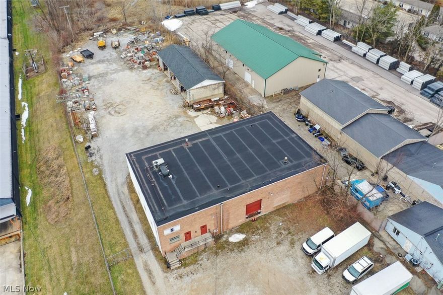 Commercial Complex On 1.3 Acres. 6,000 Sq. Ft. Shop Building W/ Offices, 2,400 Sq. Ft. Open Bay Block Building, Fenced Rear Storage Yard, Loading Dock, Convenient Location, Summit County. Live Onsite with Online Bidding. Owners no longer need this location. ABSOLUTE AUCTION, all sells to the highest bidder. ONLINE BIDDING BEGINS TUESDAY, MARCH 24, 2026, AT 9:00 AM, AND AUCTION LIVE ON-SITE BIDDING WILL BEGIN WEDNESDAY, MARCH 25, 2026, AT 12:00 PM. Real Estate Features: Summit County Parcel #6858784. The main block/brick building was built in 1972 and has a total of 6,000 sq. ft. Enter through the front to find a large reception area, 5 offices, 2 restrooms, and a coffee/kitchen area. The office area, approx. 2,000 sq. ft., is heated/cooled by its own separate rooftop HVAC system. The main shop area is approx. 60’x 60’ having 16’ ceilings, 3 overhead doors, 12’x12’ & (2) 10’x10’, with one containing a loading dock, gas Reznor overhead heat, storage mezzanine over the offices with additional office space. Great building with numerous uses. The second block building is approx. 30’x 80’ with three open bays, 18’x 12’ each, ideal equipment storage, or add overhead doors for additional shop space. The entire rear gated and fenced yard provides ample space for equipment, truck or material storage. The real estate half-year taxes are $3,050. Great property, take advantage of this opportunity! The building will be open on auction day, starting at 10:00 AM, or call for a private showing.