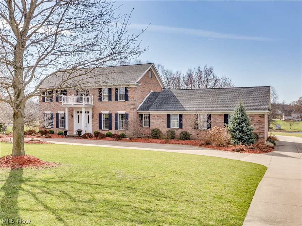 The circular drive leads up to this beautiful brick colonial w/unbelievable quality & amenities while situated on 1.24 acres w/water view* This home boosts 4 bedrooms, 2.5 baths, approx. 3754SF incl finished lower level plus vaulted sun room overlooking tranquil back yard w/composite deck, paver patio w/built in fire pit & built in seating* Many fine features includes extra wide crown molding, 6 panel oak doors, oak floor (foyer, living rm & dining) & wainscoting (formal dining rm), Bayed designer kitchen (2004) w/wood mode cabinets, granite counter top, ceramic/glass back splash, island, desk, ceramic floor, fully applianced & eating area w/Pella slider to sun room* Family room w/window wall/atrium door w/access to deck & floor to ceiling brick fireplace w/hearth & mantle* Living room adjacent to family room w/French pocket doors* 1st floor laundry w/cabinets, closet, ceramic floor & access to half bath* 2nd level w/vaulted master with double door entry, walk in plus extra closet* Up
